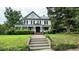Charming two-story home with a welcoming front porch and well-manicured lawn at 401 N Main St, Louisburg, NC 27549