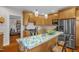 Modern kitchen with stainless steel appliances, island seating, granite countertops, and lots of storage space at 401 N Main St, Louisburg, NC 27549