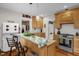 Updated kitchen with granite countertops, island with bar seating, stainless steel stove, and hardwood floors at 401 N Main St, Louisburg, NC 27549