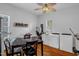 Bright laundry room with modern washer and dryer, eat-in table, and wood-look floors at 401 N Main St, Louisburg, NC 27549