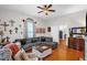 Comfortable living room featuring a sectional sofa, hardwood floors, and a bright window with sheer curtains at 401 N Main St, Louisburg, NC 27549