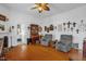 Comfortable living room with wood floors, grey chairs, fireplace, and built-in desk at 401 N Main St, Louisburg, NC 27549