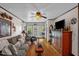 Comfortable living room with hardwood floors, cozy seating, a ceiling fan, and French doors to the outdoors at 401 N Main St, Louisburg, NC 27549