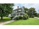 Inviting two-story home with a classic architectural design and covered side porch at 401 N Main St, Louisburg, NC 27549