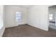 Bedroom with carpet, one window, and a door to another room at 402 Poplar St, Graham, NC 27253