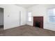 Bedroom with a brick fireplace and a single large window at 402 Poplar St, Graham, NC 27253
