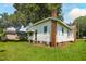 Exterior view of the home with brick foundation, white siding, and green lawn at 402 Poplar St, Graham, NC 27253