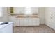 Kitchen with white cabinets, double sink, and linoleum flooring at 402 Poplar St, Graham, NC 27253