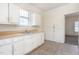 Kitchen with stainless steel double sink, wooden countertops, and white cabinets at 402 Poplar St, Graham, NC 27253