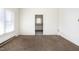 Unfurnished living room with a view into the kitchen and other rooms, showing a window and empty walls at 402 Poplar St, Graham, NC 27253