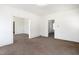 Open living room with carpeted floors and a clear view into adjacent rooms through open doorways at 402 Poplar St, Graham, NC 27253
