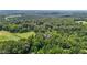 Expansive aerial view showcases the densely wooded landscape surrounding the property at 4070 Swannie Coble Rd, Snow Camp, NC 27349