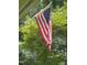 An American flag waving in the breeze with green trees in the background at 4070 Swannie Coble Rd, Snow Camp, NC 27349