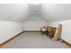 Spacious attic storage area featuring neutral carpeting and wooden trim at 4070 Swannie Coble Rd, Snow Camp, NC 27349