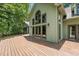 Expansive wooden deck ideal for outdoor gatherings, featuring large windows and tranquil backyard views at 4070 Swannie Coble Rd, Snow Camp, NC 27349