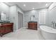 Bathroom featuring double vanities, a soaking tub, and a glass-enclosed shower at 4070 Swannie Coble Rd, Snow Camp, NC 27349