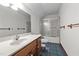 Bathroom with a wood vanity, updated sink, and a shower with sliding glass doors at 4070 Swannie Coble Rd, Snow Camp, NC 27349