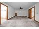 Large bedroom with carpeted floors, neutral walls, and multiple doorways at 4070 Swannie Coble Rd, Snow Camp, NC 27349