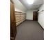 Walk-in closet with custom shelving and dark wood door at 4070 Swannie Coble Rd, Snow Camp, NC 27349