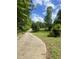Long concrete driveway leading up to the property and surrounded by trees at 4070 Swannie Coble Rd, Snow Camp, NC 27349
