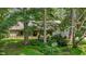 Ranch-style home with a covered front porch surrounded by mature trees and greenery at 4070 Swannie Coble Rd, Snow Camp, NC 27349