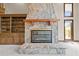 Close-up of the stone fireplace with wooden beam mantel and built-in shelves at 4070 Swannie Coble Rd, Snow Camp, NC 27349