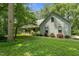 Beautiful home with a spacious front yard, mature trees, and an inviting front porch at 4070 Swannie Coble Rd, Snow Camp, NC 27349