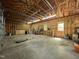 Large garage interior, featuring high ceilings, open walls, and concrete flooring at 4070 Swannie Coble Rd, Snow Camp, NC 27349