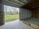 Open garage offering ample space and a view of the landscaped backyard at 4070 Swannie Coble Rd, Snow Camp, NC 27349