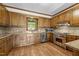 Well-lit kitchen featuring wooden cabinetry, stainless steel appliances, and granite countertops at 4070 Swannie Coble Rd, Snow Camp, NC 27349
