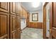Spacious laundry room featuring wooden cabinetry, sink, and tile flooring at 4070 Swannie Coble Rd, Snow Camp, NC 27349