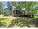 Rear exterior view featuring a screened porch and a spacious wooden deck for outdoor living at 4070 Swannie Coble Rd, Snow Camp, NC 27349