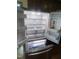 Interior view of the stainless steel refrigerator, showcasing ample storage space at 4070 Swannie Coble Rd, Snow Camp, NC 27349