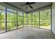 Sunroom with large screened windows and ceramic tile flooring provides natural light at 4070 Swannie Coble Rd, Snow Camp, NC 27349