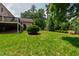 Large, grassy backyard with mature trees and a multi-level deck at 4517 Gates St, Raleigh, NC 27609