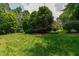 Manicured backyard with lush landscaping and a basketball hoop at 4517 Gates St, Raleigh, NC 27609