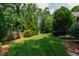 Expansive green backyard with established shrubs and tree coverage at 4517 Gates St, Raleigh, NC 27609
