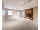 Spacious finished basement with a brick fireplace and neutral carpeting at 4517 Gates St, Raleigh, NC 27609