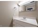 Basement bathroom with a white vanity, neutral paint and a mirror at 4517 Gates St, Raleigh, NC 27609