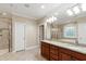 Bathroom with double vanity sinks, soaking tub, and glass enclosed shower at 4517 Gates St, Raleigh, NC 27609