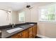 Bathroom featuring a double sink vanity with dark countertops and a window at 4517 Gates St, Raleigh, NC 27609