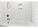 Bathroom featuring a white tiled shower and bathtub with niche shelving at 4517 Gates St, Raleigh, NC 27609