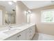 Bright bathroom features double sinks, white cabinetry, and marble flooring at 4517 Gates St, Raleigh, NC 27609