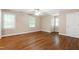 Spacious bedroom with hardwood floors, many windows, and a ceiling fan at 4517 Gates St, Raleigh, NC 27609