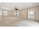 Large bedroom with neutral carpet, ceiling fan, and adjoining bathroom at 4517 Gates St, Raleigh, NC 27609