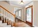 Inviting entryway boasts hardwood floors, elegant staircase, and stained glass front door at 4517 Gates St, Raleigh, NC 27609