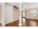 Inviting entryway boasts hardwood floors, elegant staircase, and stained glass front door at 4517 Gates St, Raleigh, NC 27609