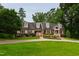 Well-maintained home with dormer windows, brick accents, and lush yard at 4517 Gates St, Raleigh, NC 27609