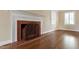 Living room fireplace with brick surround, hearth and decorative screen at 4517 Gates St, Raleigh, NC 27609