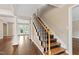 Hallway with hardwood floors, stairs and white pillars at 4517 Gates St, Raleigh, NC 27609